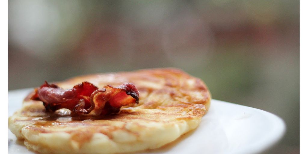 maple syrup bottle 50ml with pancakes and waffles in a cozy kitchen